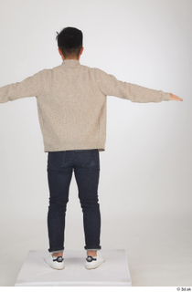 Yoshinaga Kuri blue jeans brown sweater casual dressed standing t…